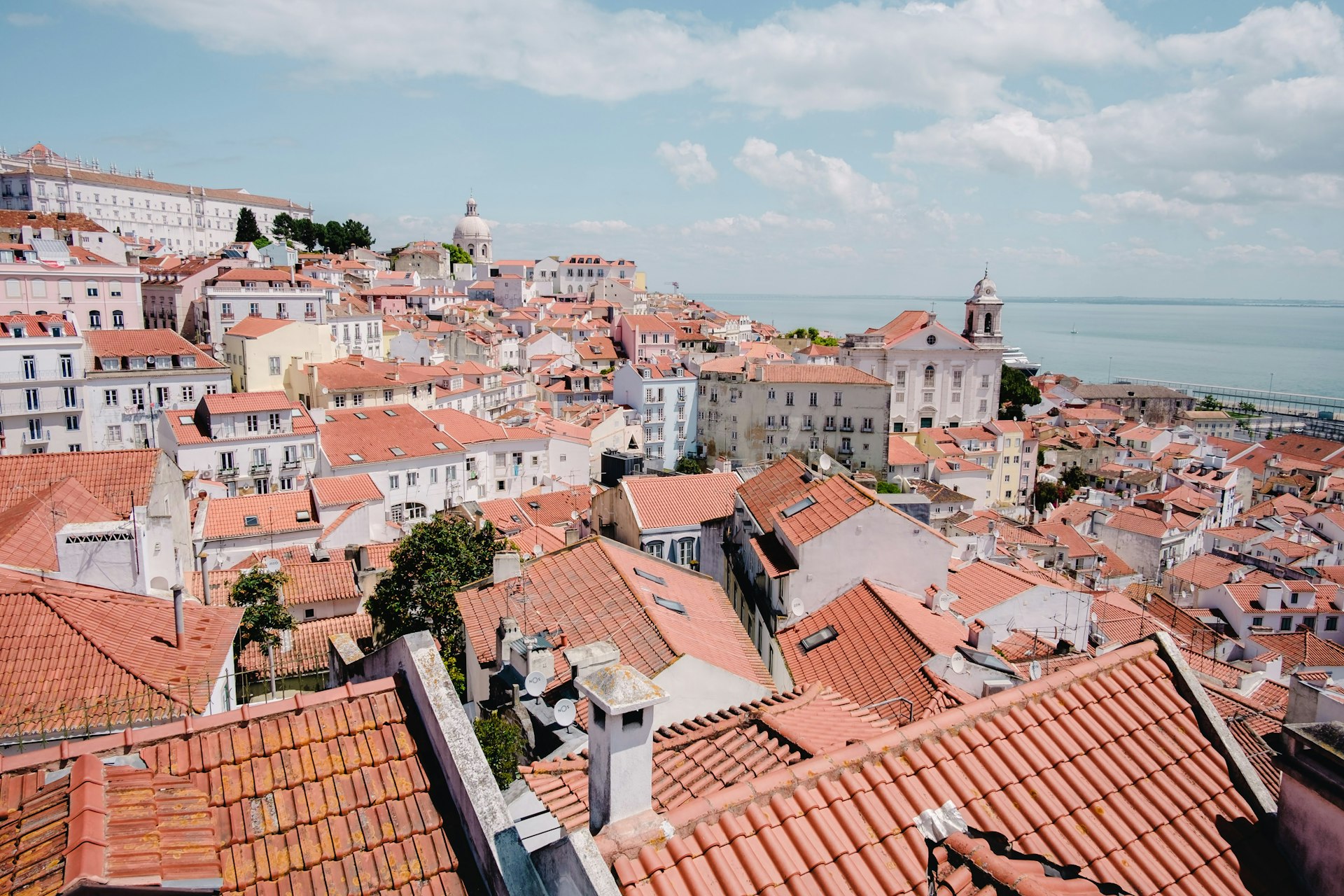 Lisbon rooftops and river in Portugal